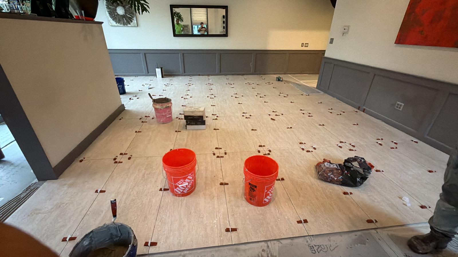 Large-format restaurant floor tile installation in progress