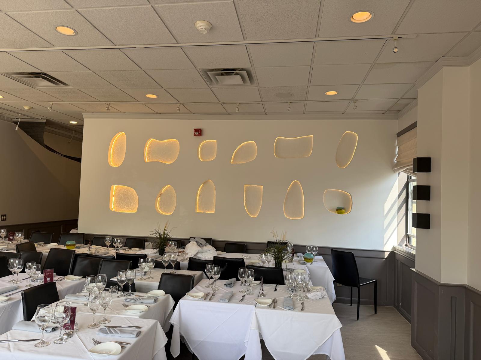 Completed New York City restaurant dining room with refined wall details and warm lighting
