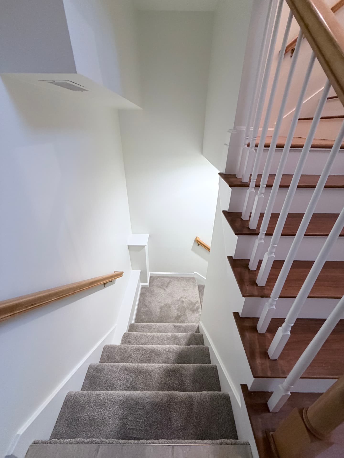 Painted stairwell with crisp white walls, trim and railings