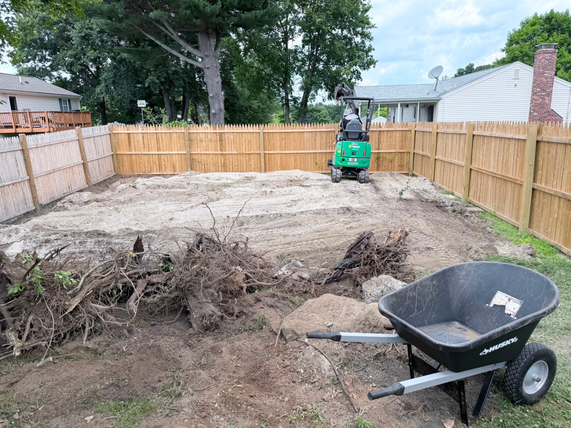 Backyard clearing and ground preparation in progress